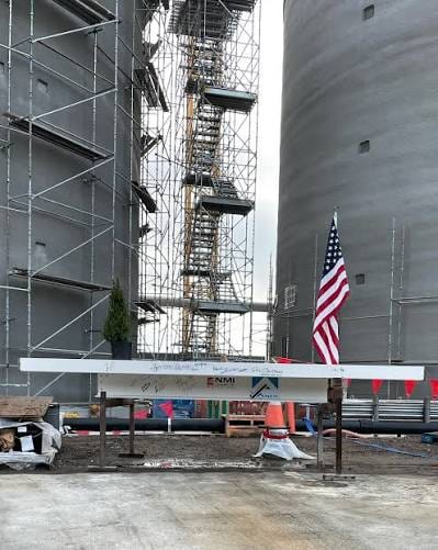 Avalon and NMI structural steel installation with an American flag